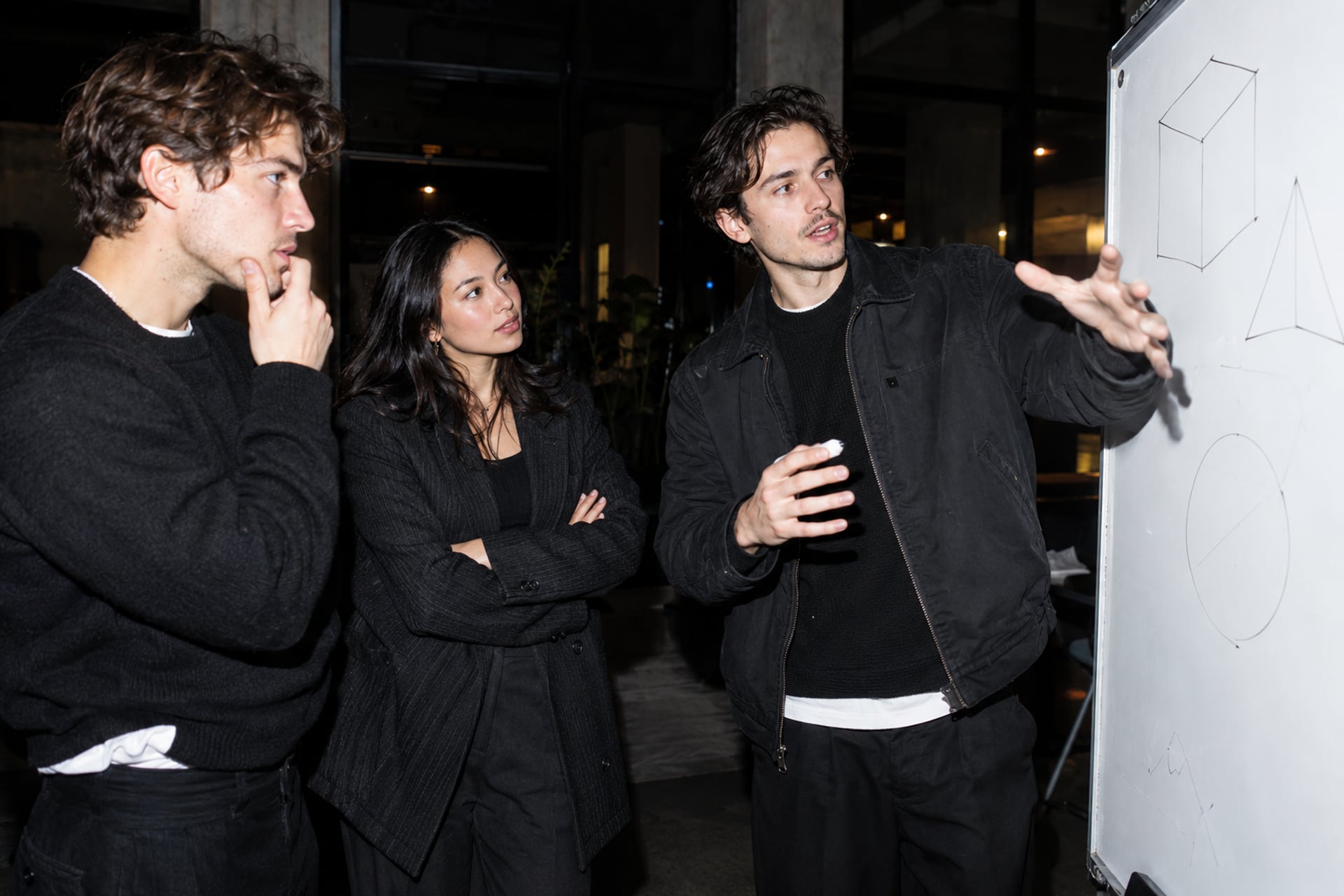 Founders discuss a sketch in a Stockholm loft workshop.