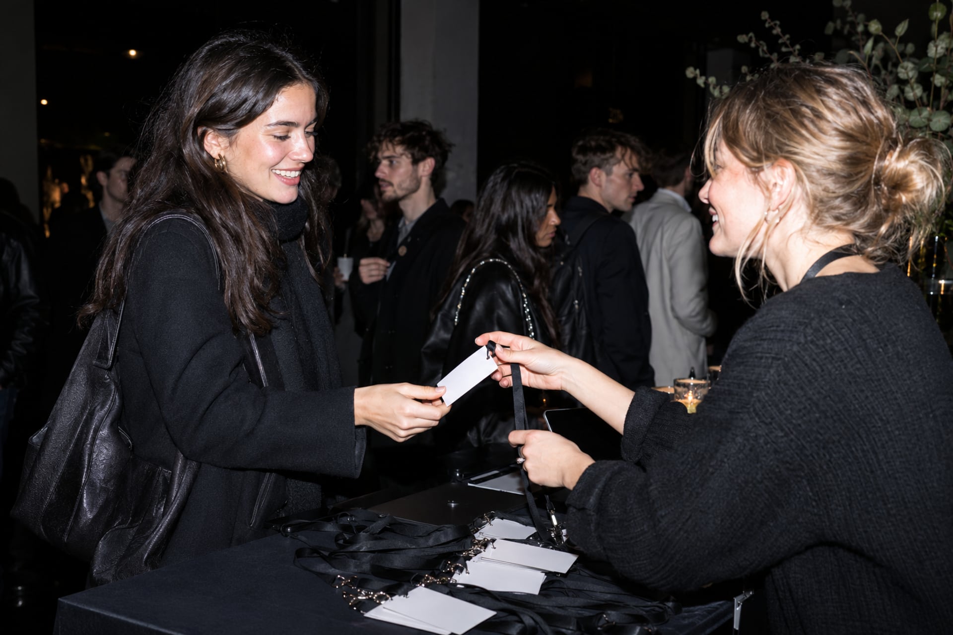 A volunteer welcomes an attendee at a Stockholm meetup.