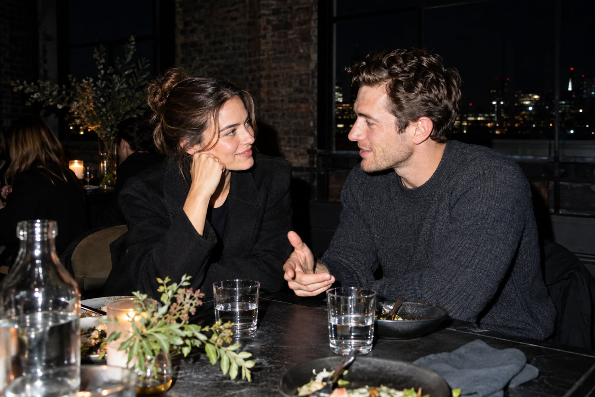 Two founders share a thoughtful conversation at a London loft dinner.