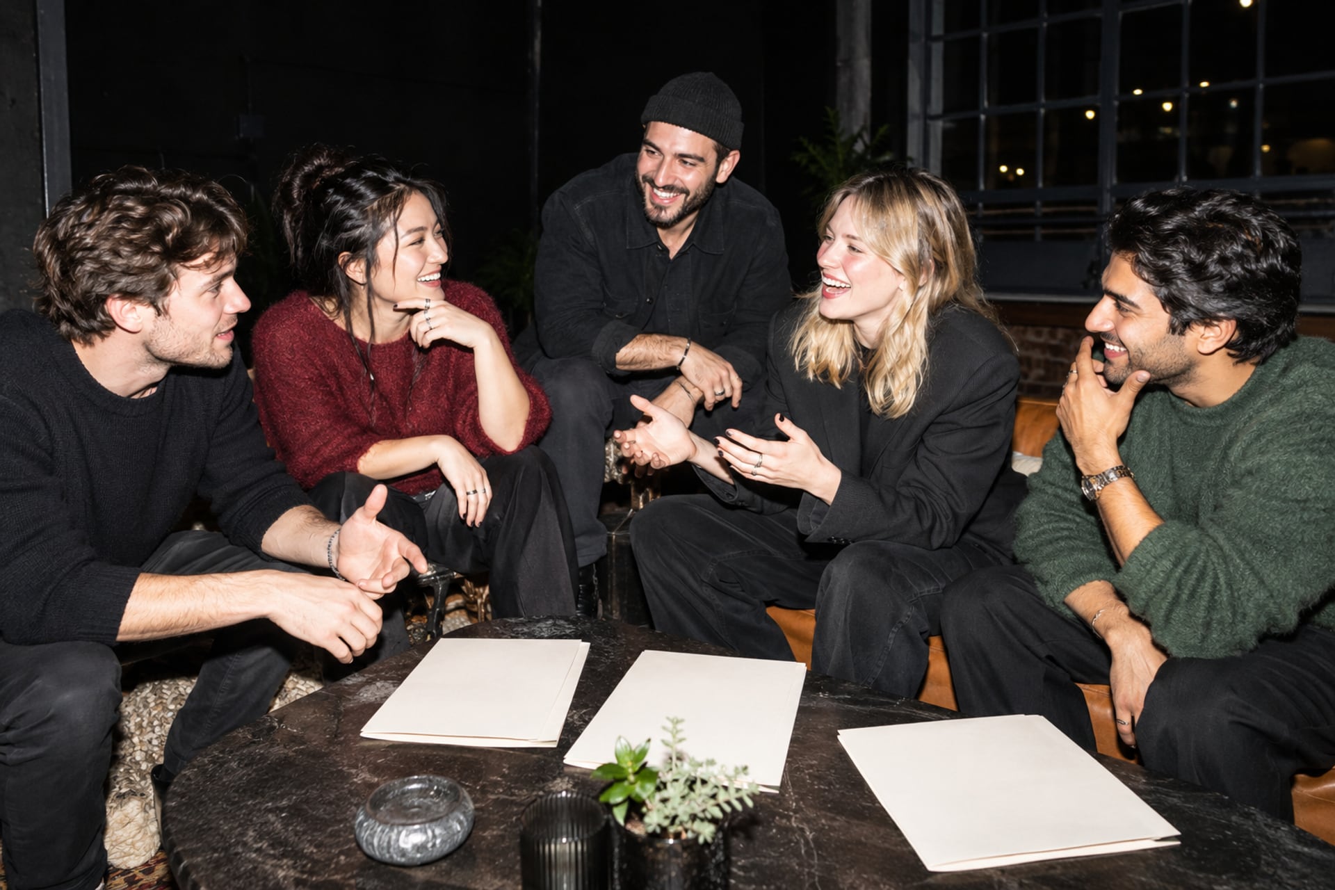 Founders laugh over folders in a San Francisco lounge after dark.