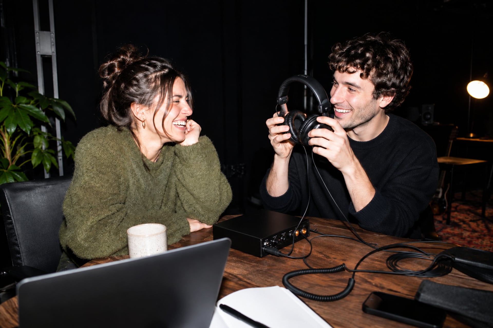 Two audio makers share a listening break in a London studio after dark.